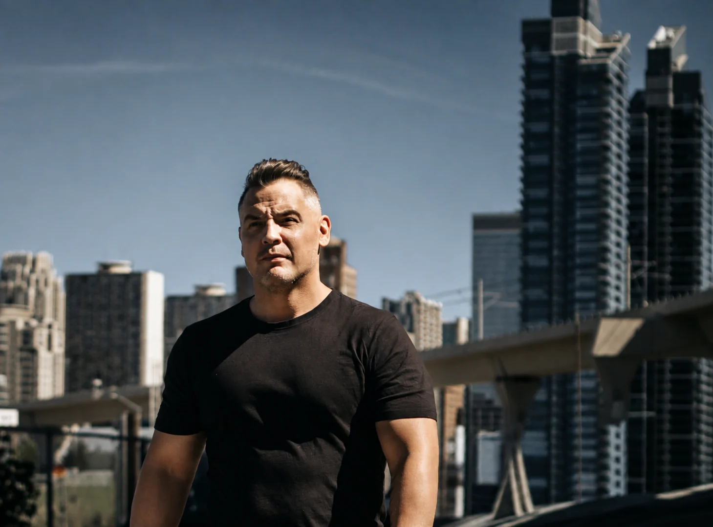 Austan Sloan, founder of Recover-You, outdoors with a city skyline